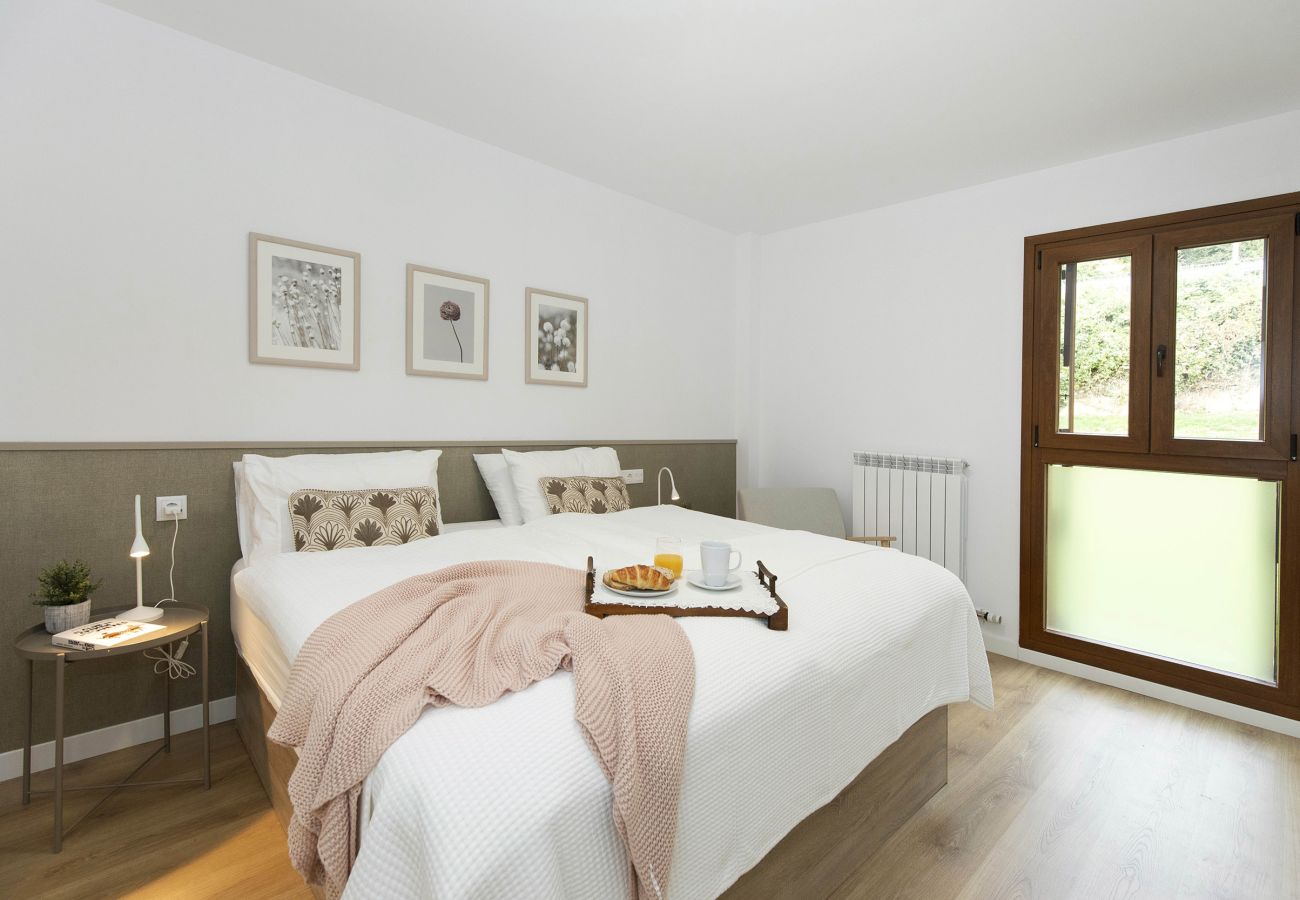 Modern-style master bedroom with a window and views in a family apartment in Panticosa.