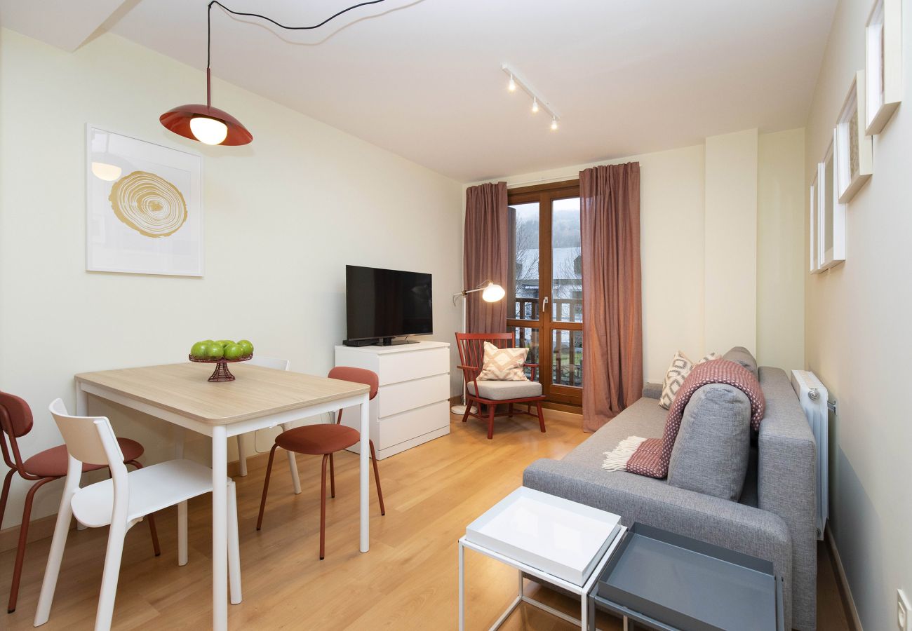 Modern and comfortable living room with natural light in a holiday apartment in Escarrilla.